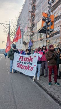 A group of people holding a banner AI-generated content may be incorrect.